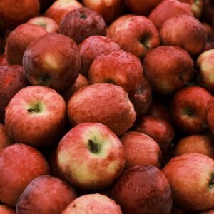 A vivid close-up of fresh, dewy red apples, perfect for healthy food concepts.