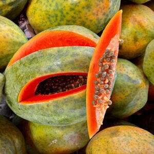 Vibrant ripe papayas on display, showcasing rich orange flesh and seeds.