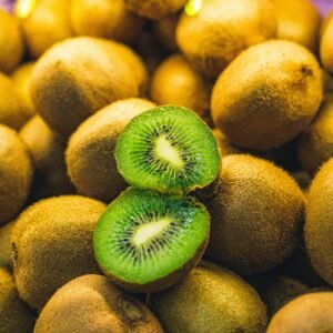 Vibrant fresh kiwi fruits with a sliced center showcasing bright green texture.