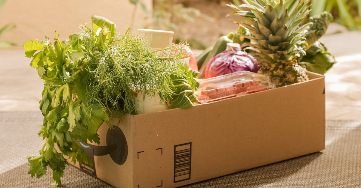 A cardboard box filled with fresh vegetables and fruits, perfect for delivery or online shopping.